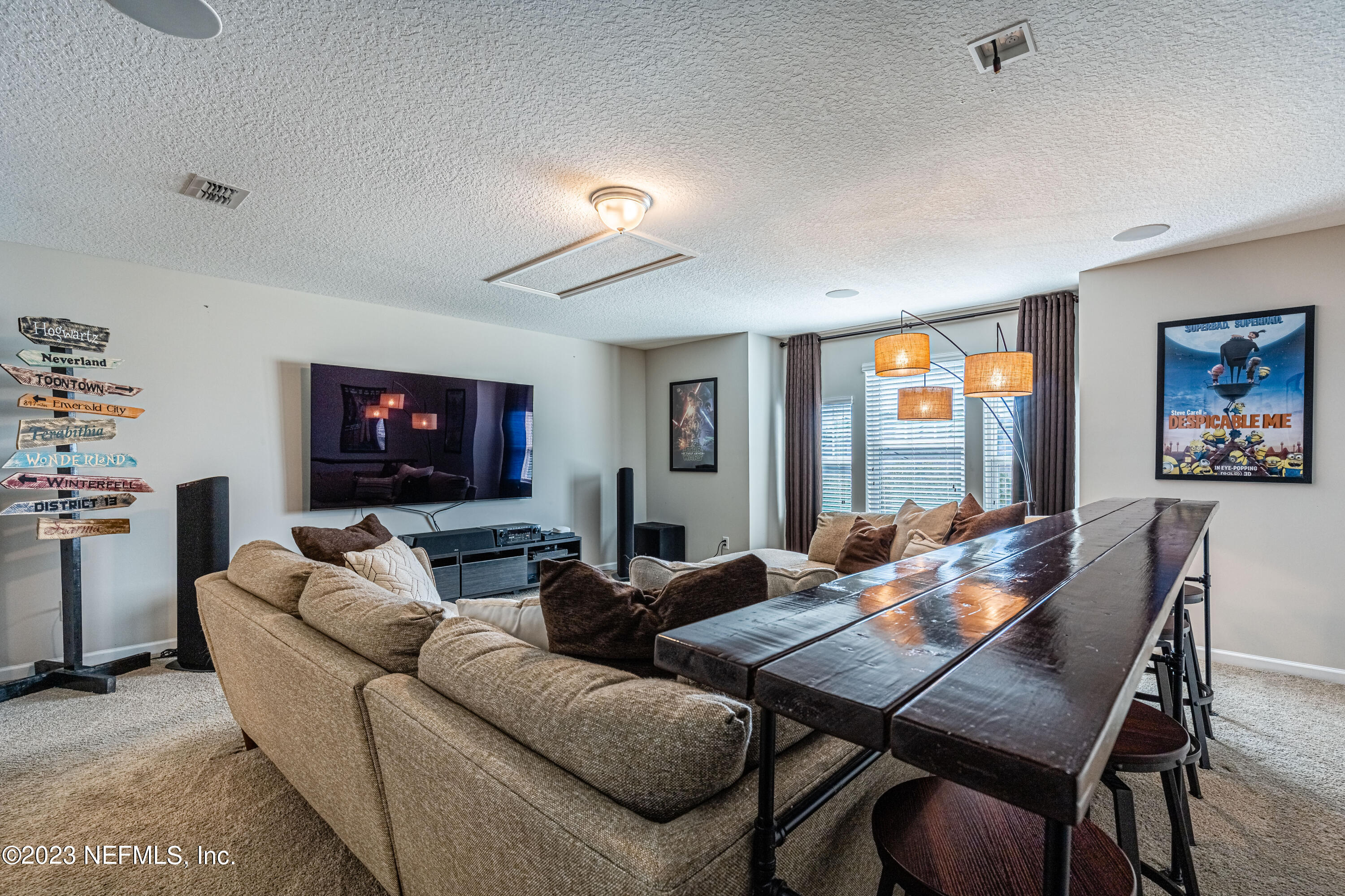 871 Bent Creek Drive St. Johns, FL 32259 - Photo 44 of 71 a living room with furniture a flat screen tv and a fireplace