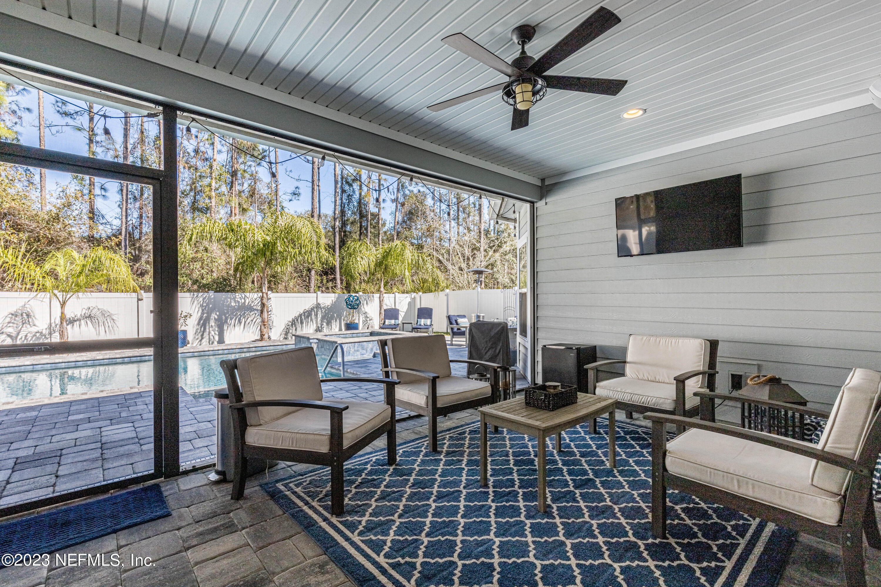 871 Bent Creek Drive St. Johns, FL 32259 - Photo 49 of 71 a living room with furniture a flat screen tv and a large window