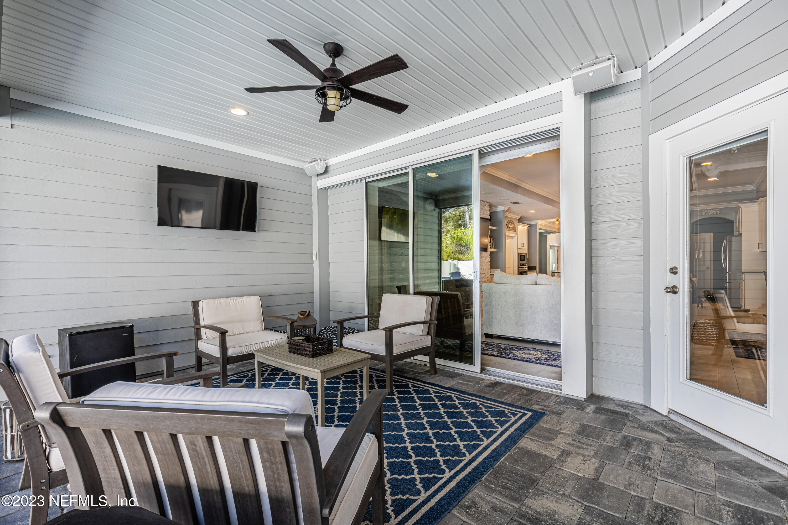 871 Bent Creek Drive St. Johns, FL 32259 - Photo 50 of 71 a living room with furniture a flat screen tv and a table