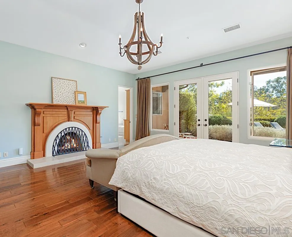 13657 Paseo De La Huerta Poway, CA 92064 - Photo 15 of 38 a bedroom with a bed and a large window