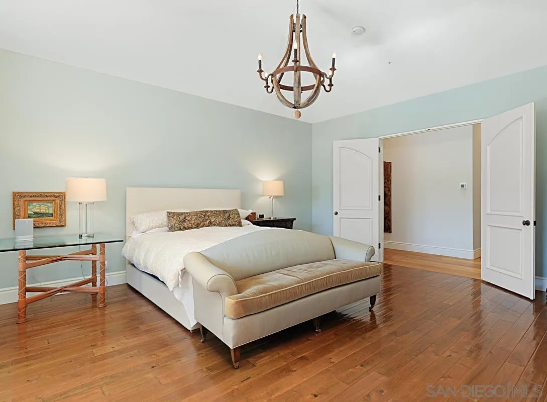 13657 Paseo De La Huerta Poway, CA 92064 - Photo 16 of 38 a spacious bedroom with a bed and a table in it