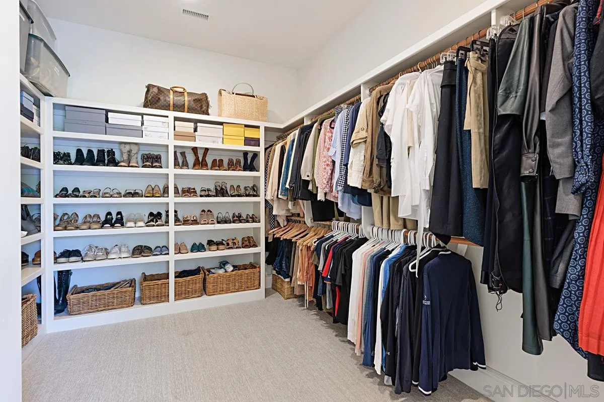 13657 Paseo De La Huerta Poway, CA 92064 - Photo 19 of 38 a view of walk in closet with clothes and shoes