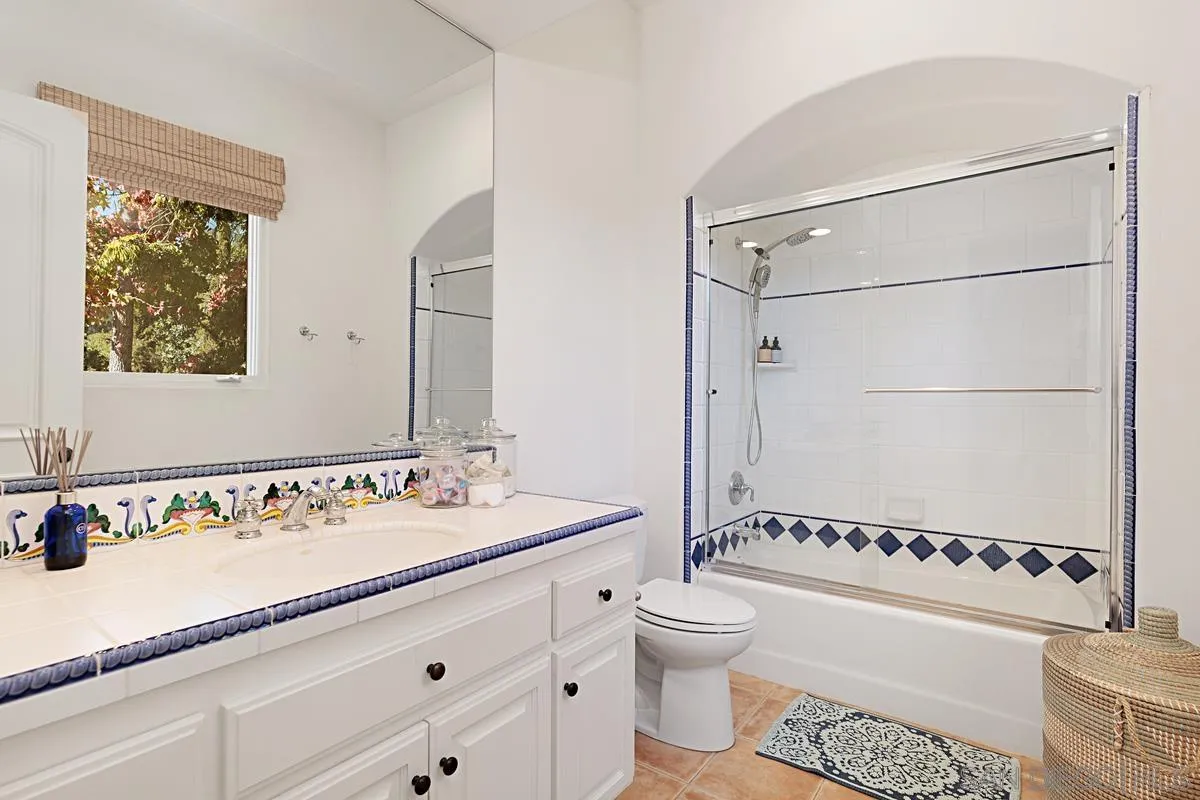 13657 Paseo De La Huerta Poway, CA 92064 - Photo 21 of 38 a bathroom with a sink a toilet and a mirror