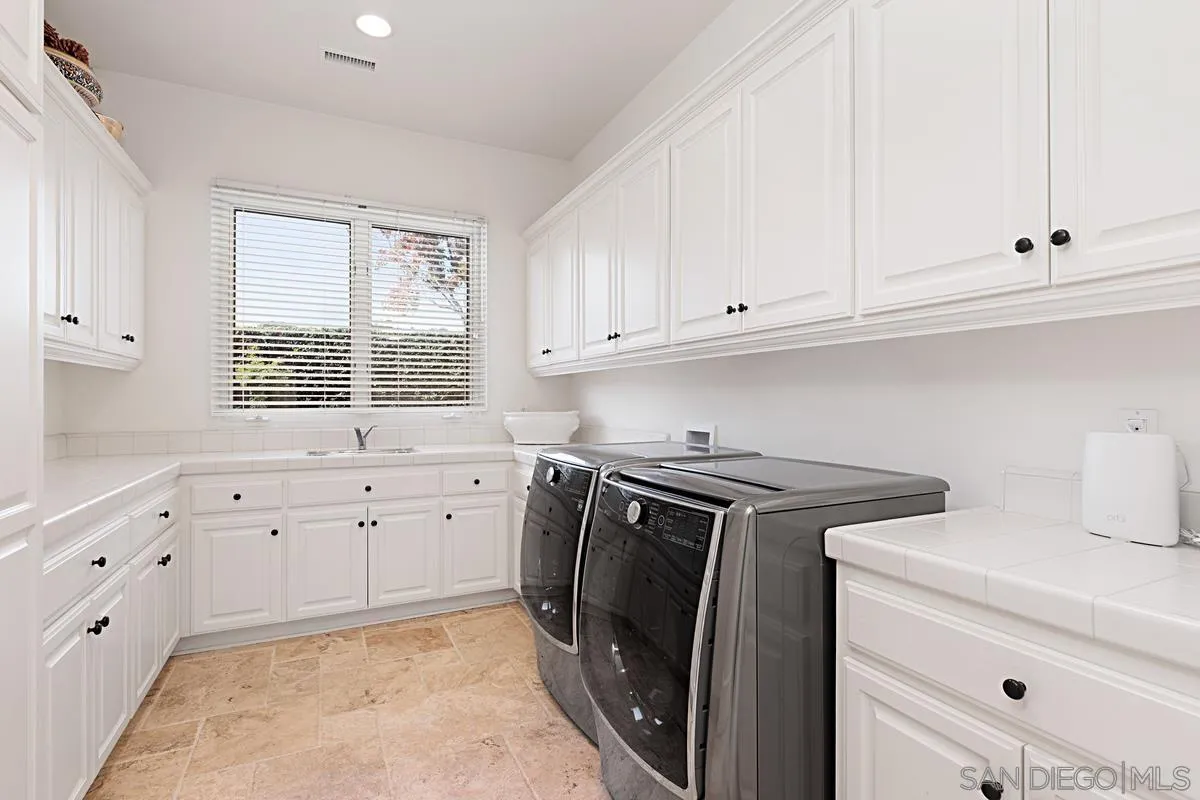 13657 Paseo De La Huerta Poway, CA 92064 - Photo 26 of 38 a kitchen with granite countertop white cabinets and stainless steel appliances