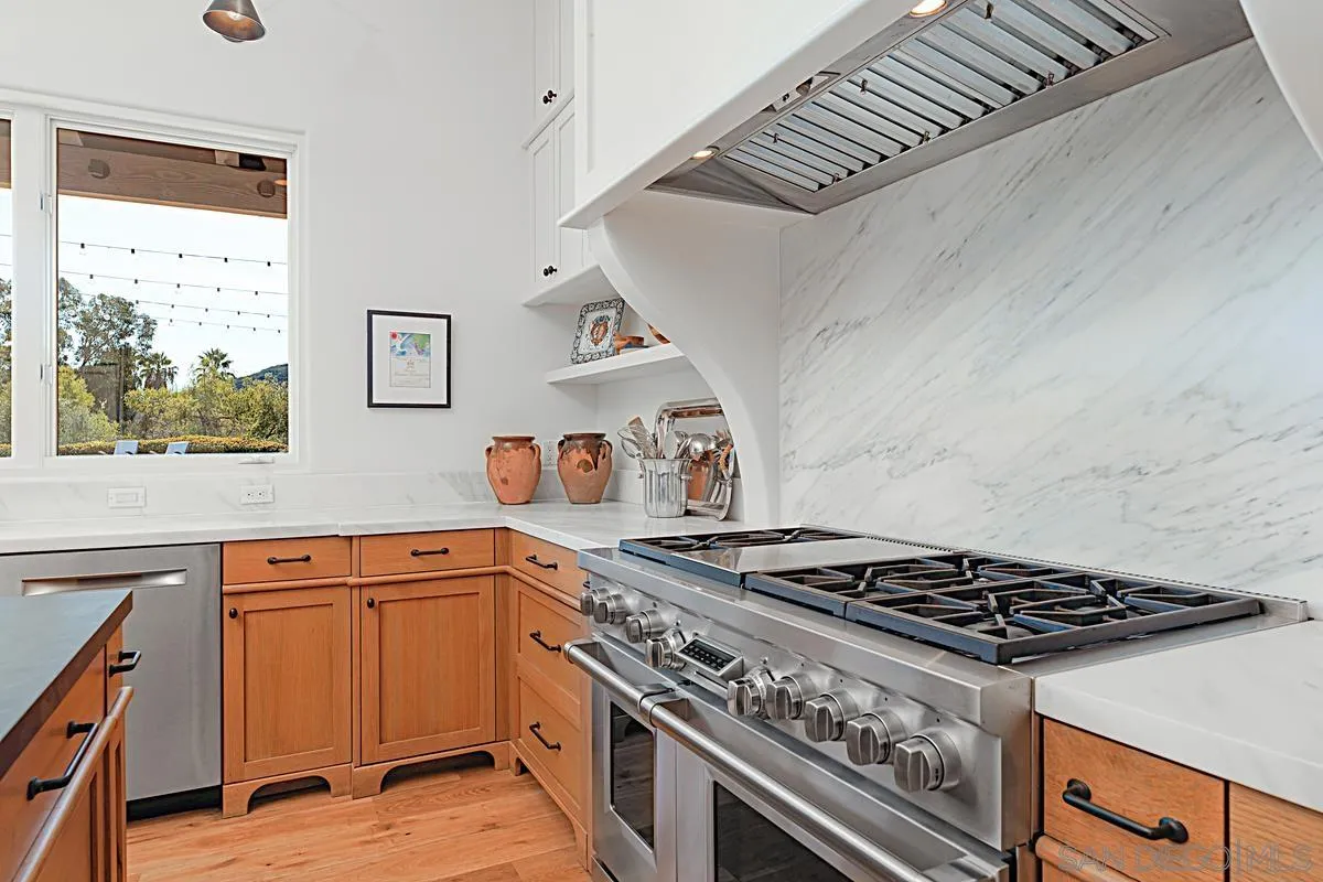 13657 Paseo De La Huerta Poway, CA 92064 - Photo 9 of 38 a stove top oven sitting inside of a kitchen