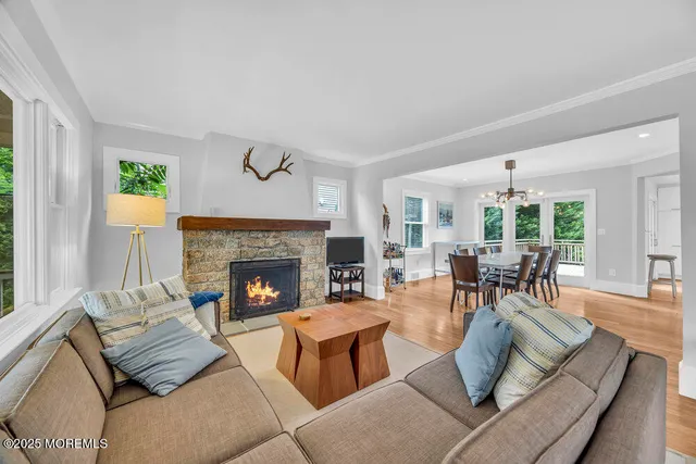 a living room with furniture fireplace and window