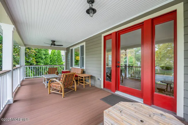 a balcony with chairs and wooden floor