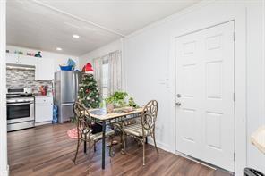 1713 Sycamore Street Commerce, TX 75428 - Photo 10 of 22 a view of a dining room with furniture and wooden floor