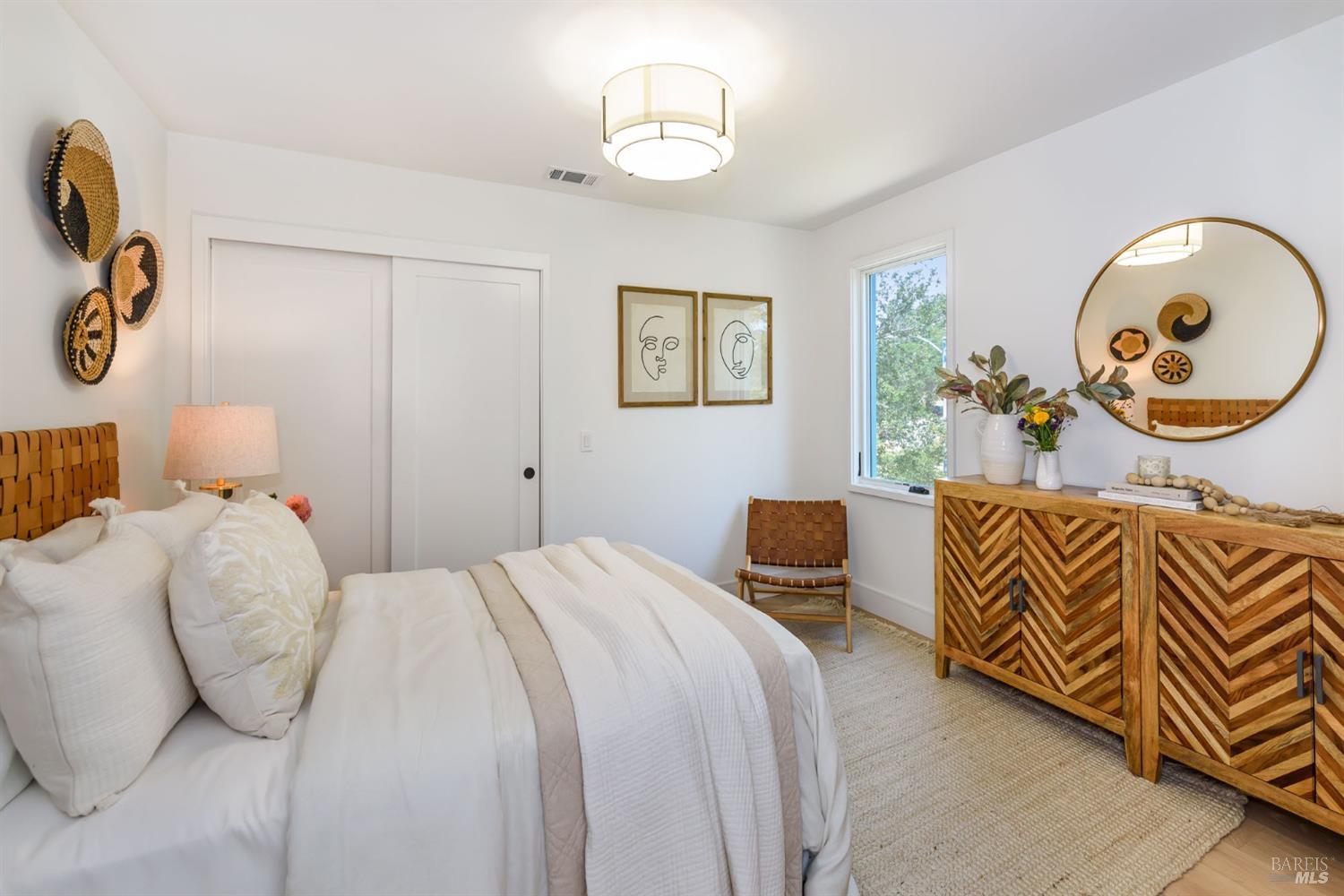 1068 Foster Road Napa, CA 94558 - Photo 15 of 18 a bedroom with a bed and a chandelier