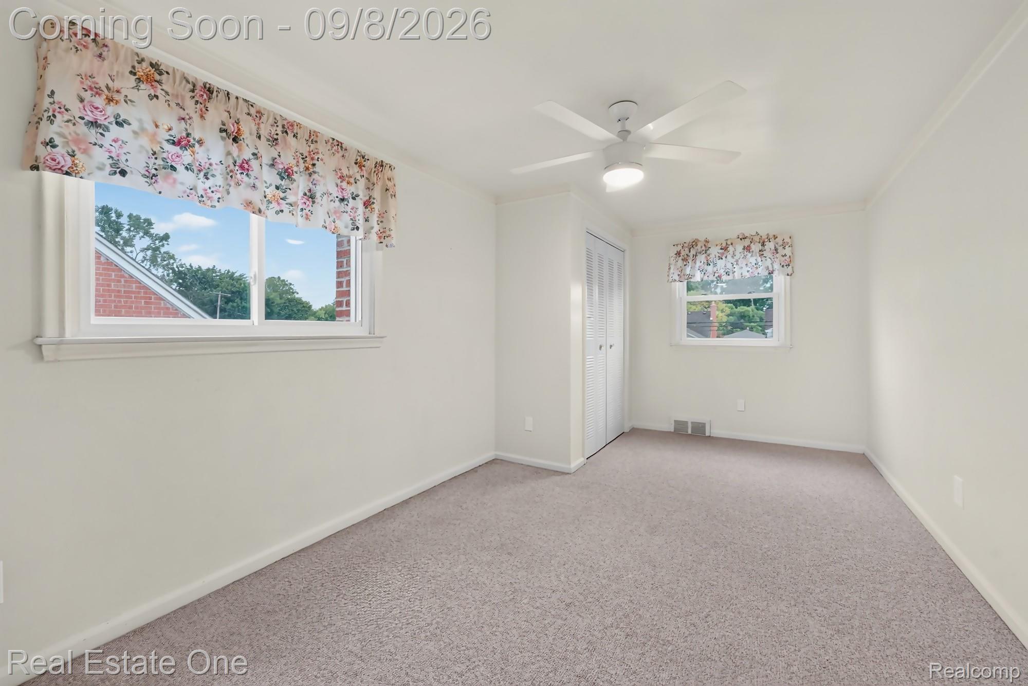 7961 Merrick Street Taylor, MI 48180 - Photo 24 of 39 Neutral carpeting, white painted walls, and a ceiling fan with integrated lighting