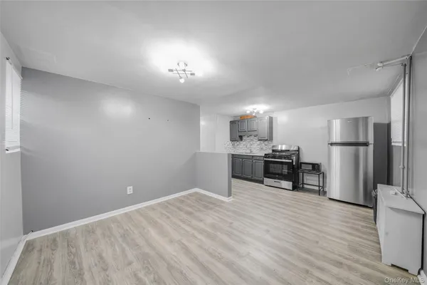 a view of kitchen with refrigerator microwave and wooden floor