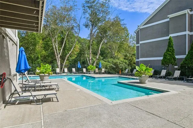 a view of backyard with swimming pool and outdoor seating