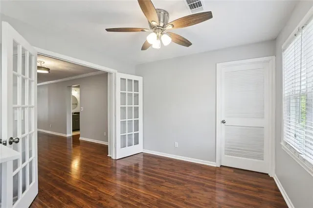 wooden floor in an empty room with a window