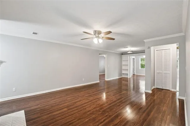 a view of an empty room with wooden floor