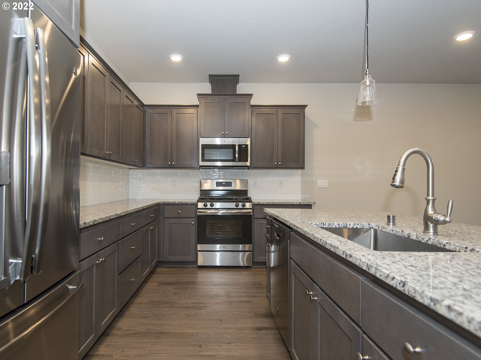 37372 Pink Street, Unit HS 71 Sandy, OR 97055 - Photo 4 of 7 a kitchen with stainless steel appliances granite countertop a sink stove and refrigerator