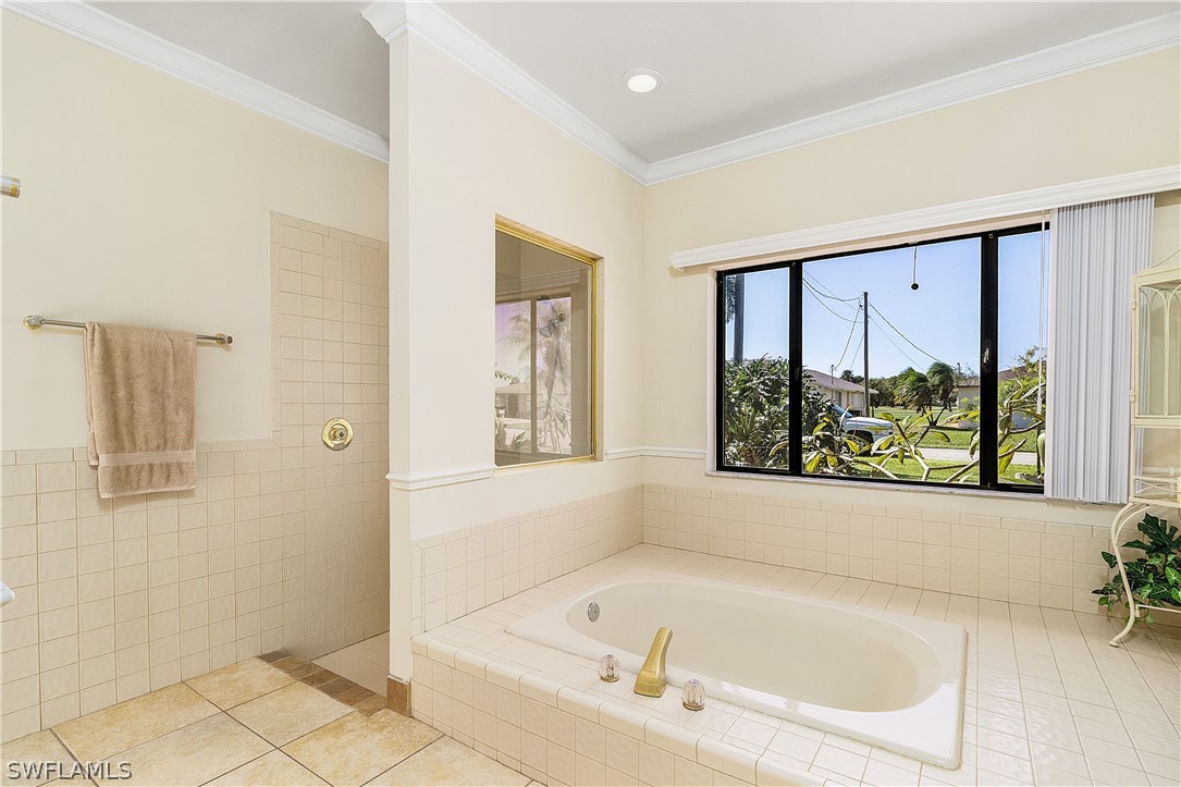 17601 Laurel Valley Road Fort Myers, FL 33967 - Photo 15 of 25 a white bath tub sitting in a bathroom next to a window