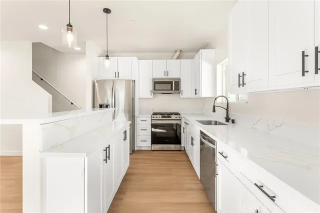 a kitchen with stainless steel appliances a stove sink and cabinets