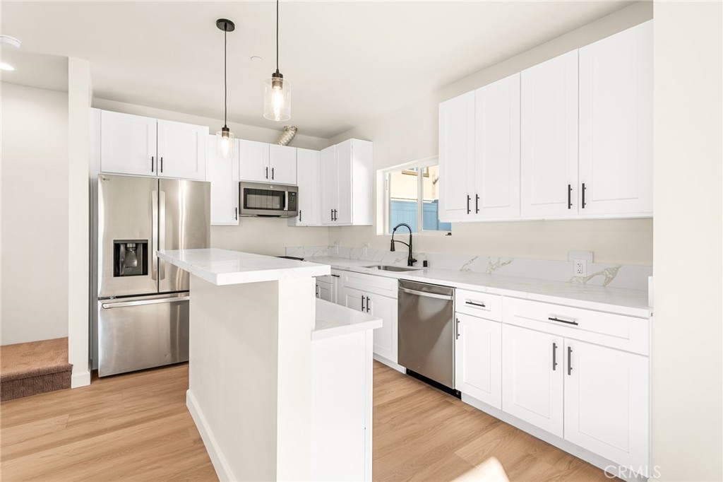 904 South Hert Street Colton, CA 92324 - Photo 15 of 35 a kitchen with white cabinets and stainless steel appliances