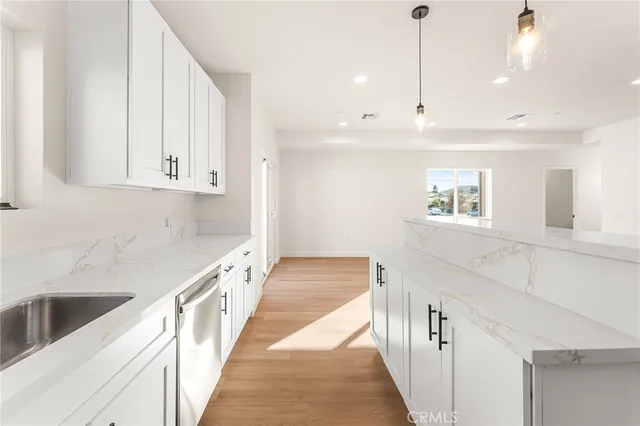 a view of a kitchen with wooden floor