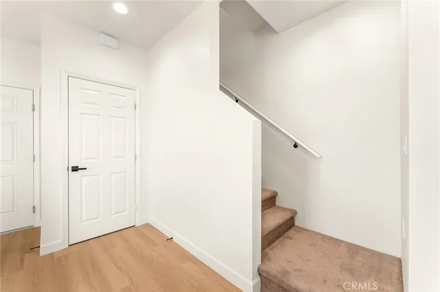 a view of a room with wooden floor