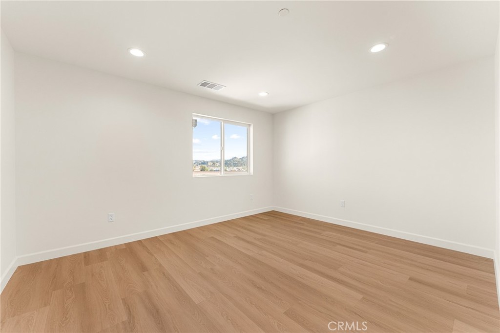 904 South Hert Street Colton, CA 92324 - Photo 23 of 35 an empty room with wooden floor and windows