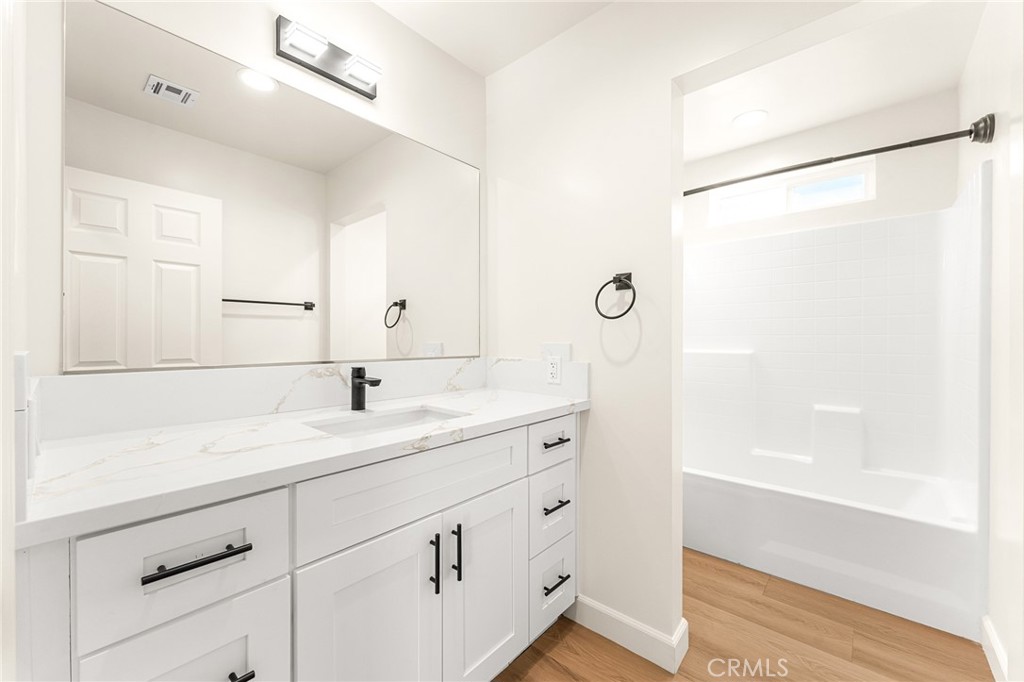 904 South Hert Street Colton, CA 92324 - Photo 29 of 35 a bathroom with a shower sink and mirror