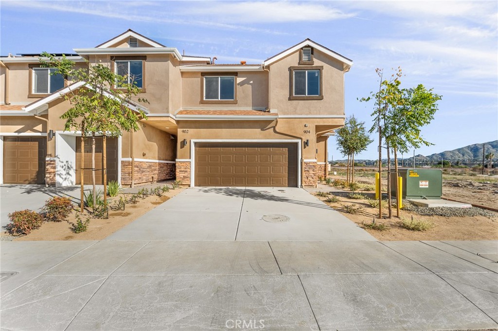 904 South Hert Street Colton, CA 92324 - Photo 3 of 35 a front view of a house with a yard and garage