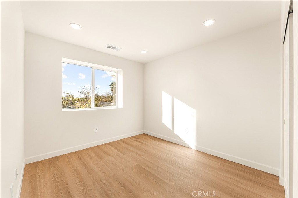904 South Hert Street Colton, CA 92324 - Photo 31 of 35 an empty room with wooden floor and windows