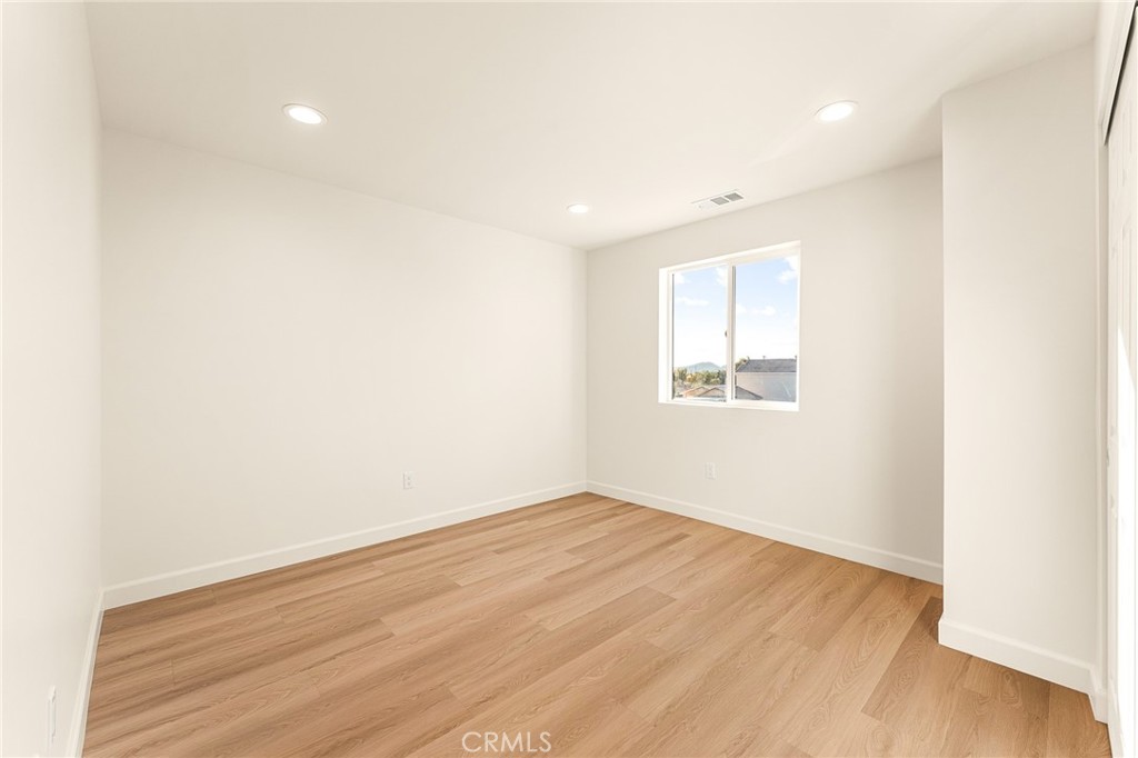 904 South Hert Street Colton, CA 92324 - Photo 32 of 35 an empty room with wooden floor and windows