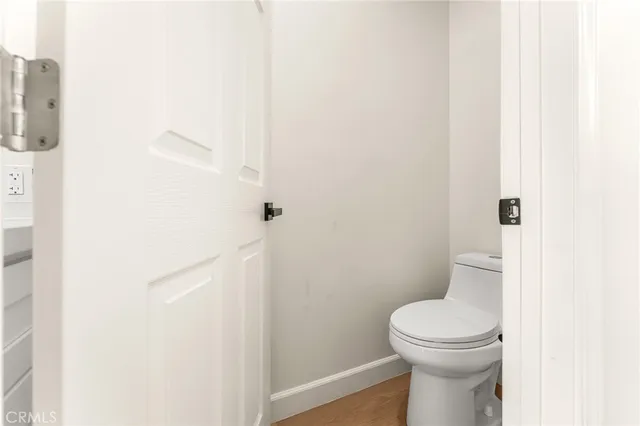 a white toilet sitting next to a shower