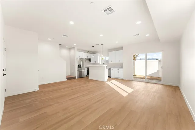 a view of a kitchen with a sink and a window