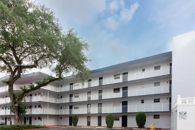 a view of a building with a large tree