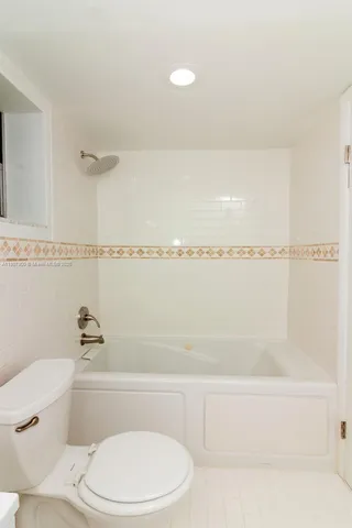 a bathroom with a toilet a sink and vanity