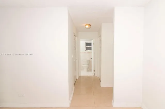 a view of a kitchen with a sink and a large window