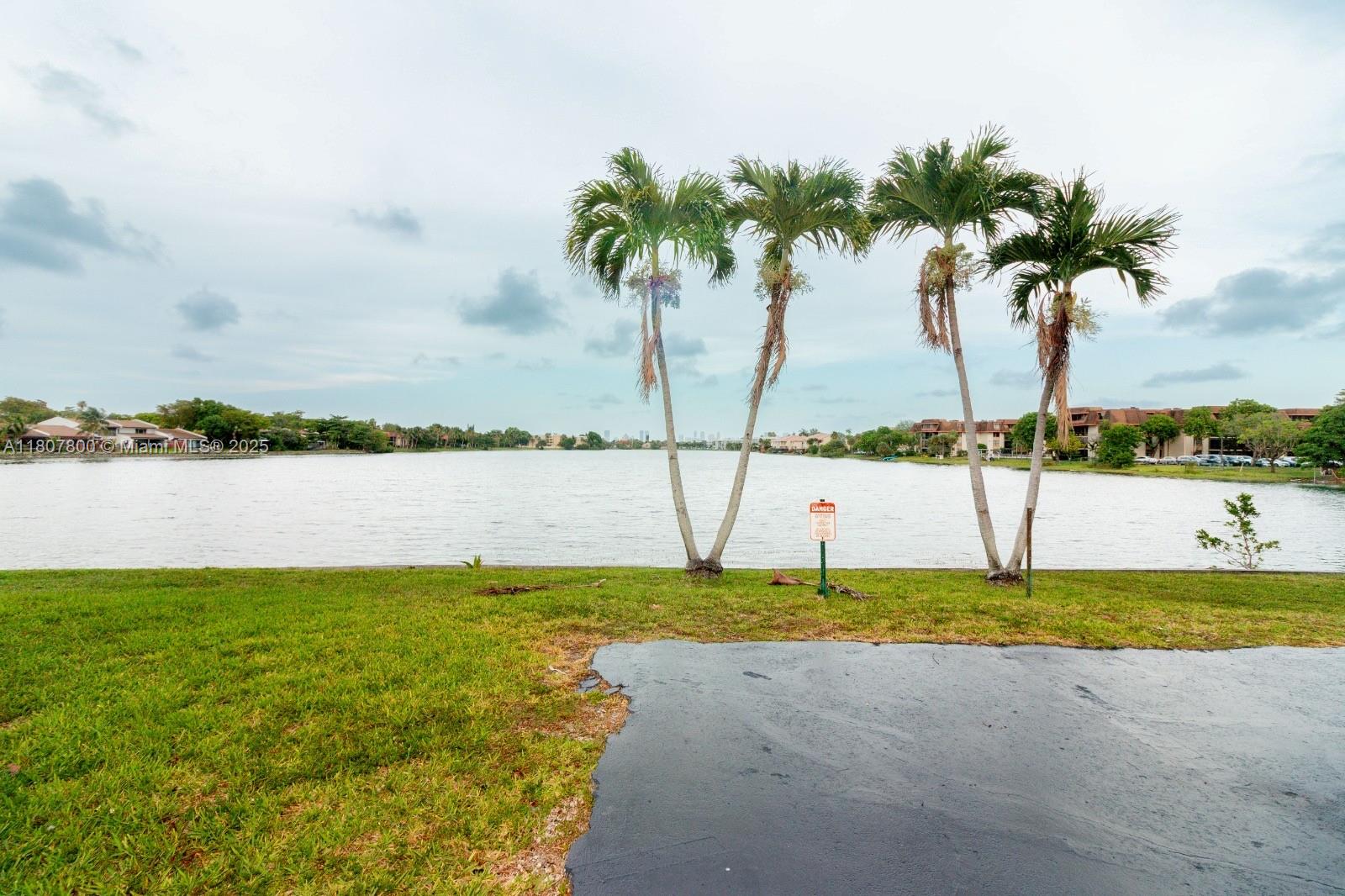 447 Northeast 195th Street, Unit 217 Miami, FL 33179 - Photo 8 of 22 a view of swimming pool with a yard