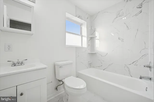 a bathroom with a sink toilet and bathtub