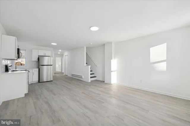 a view of a kitchen with a sink and a refrigerator