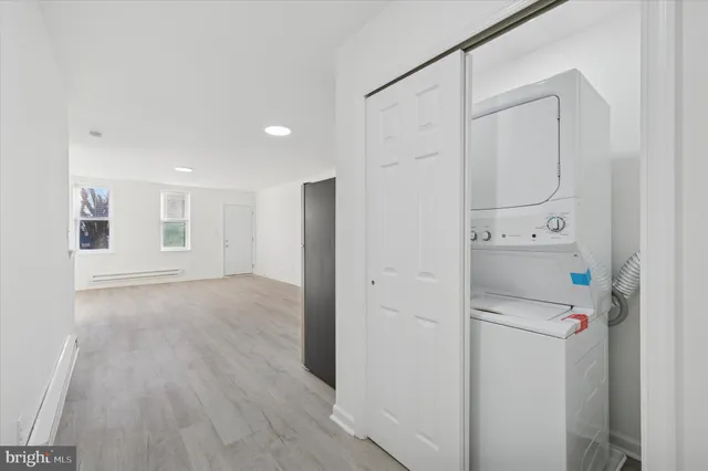 a room with white cabinets and wooden floor