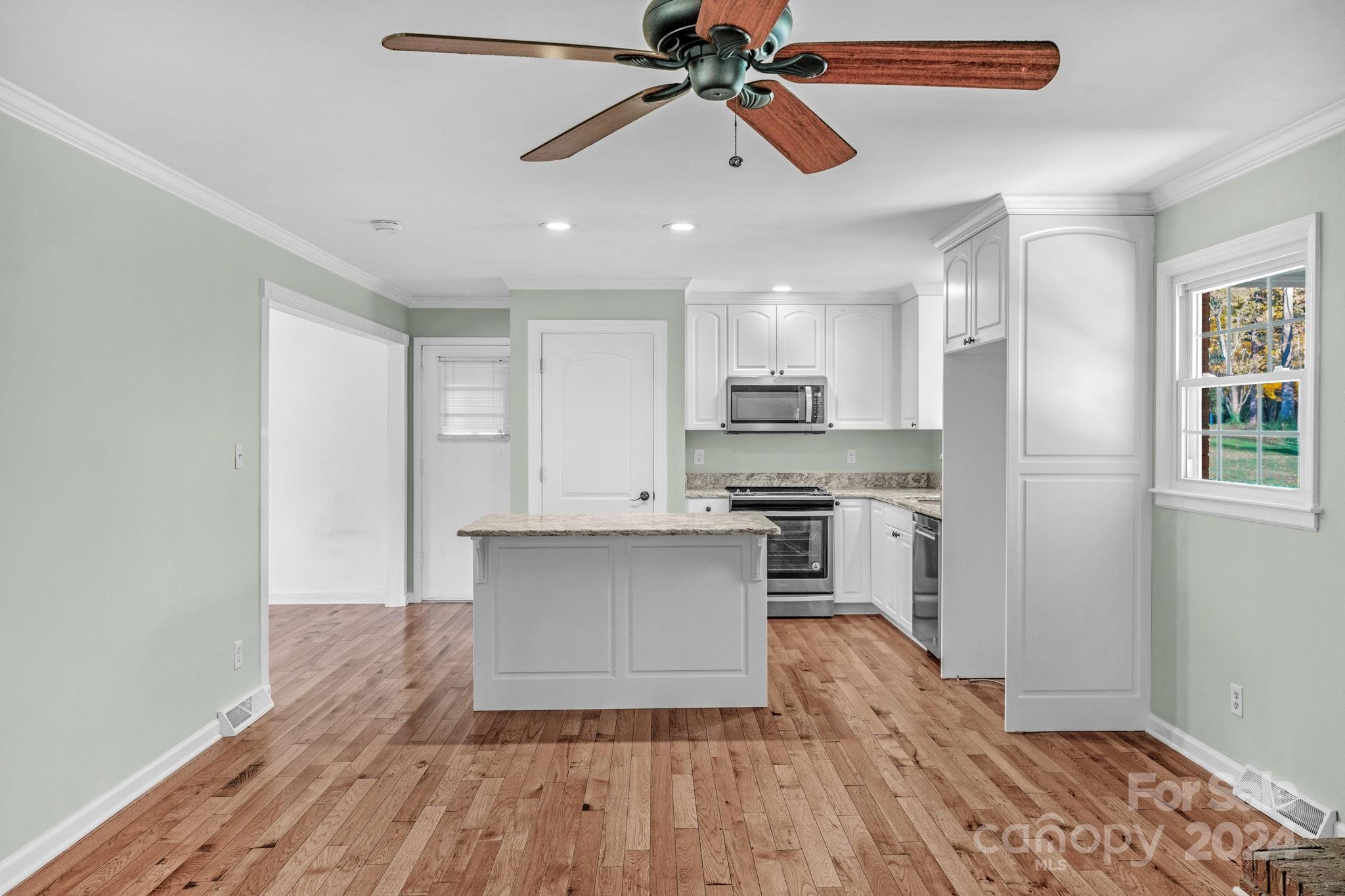 3704 Pinecrest Drive Gastonia, NC 28056 - Photo 23 of 48 a kitchen with a refrigerator and white cabinets