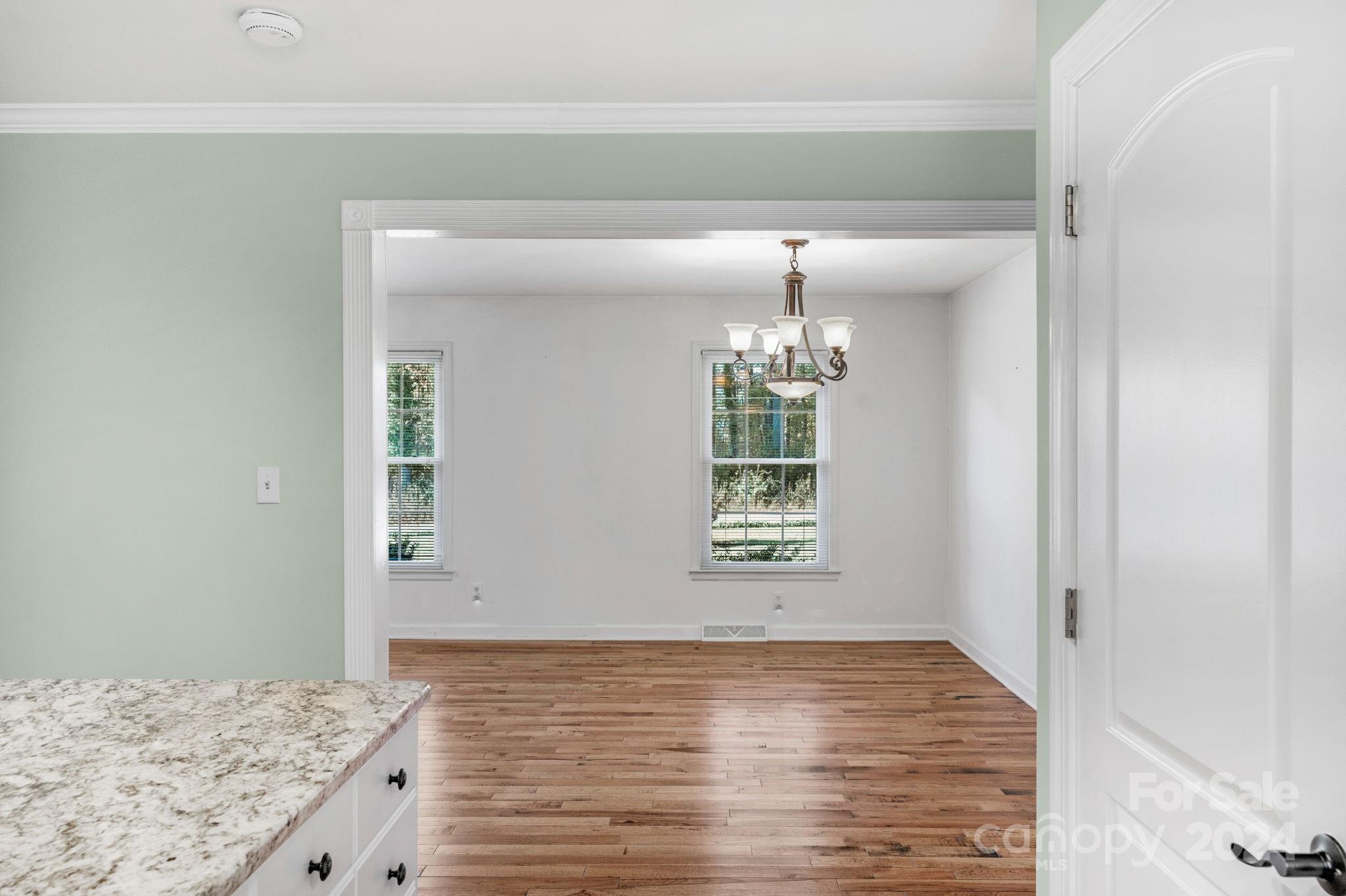 3704 Pinecrest Drive Gastonia, NC 28056 - Photo 24 of 48 a view of an empty room with window and wooden floor