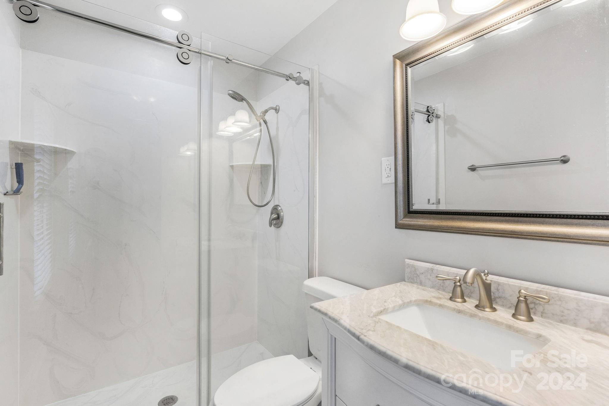 3704 Pinecrest Drive Gastonia, NC 28056 - Photo 35 of 48 a bathroom with a granite countertop sink toilet and shower