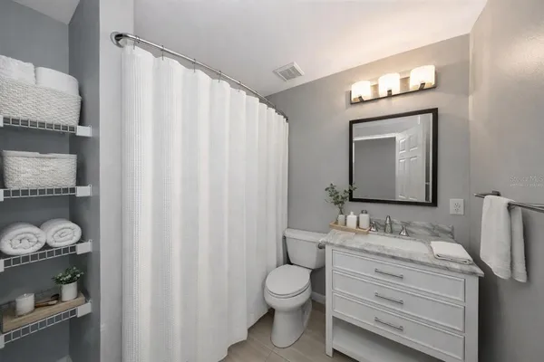 a bathroom with a toilet a sink and a mirror