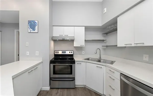 a kitchen with cabinets appliances and a sink