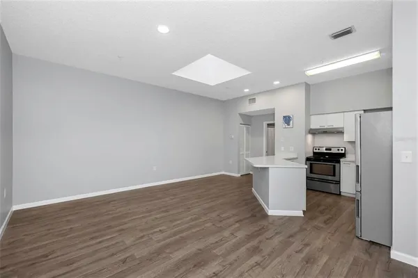 a kitchen with kitchen island refrigerator sink and stove