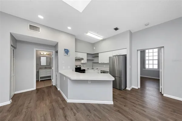a kitchen with refrigerator and window