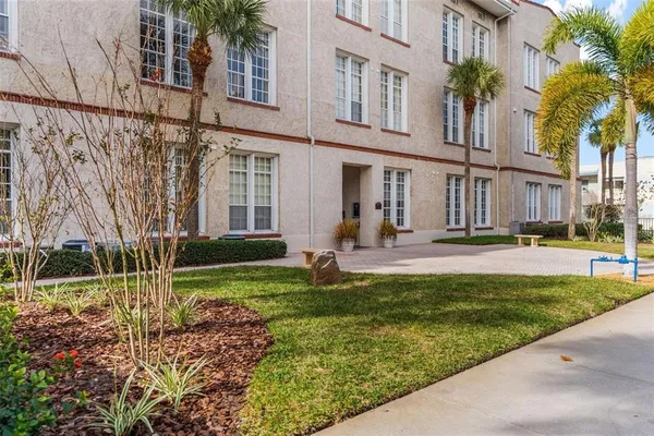 a view of a house with a yard and plants