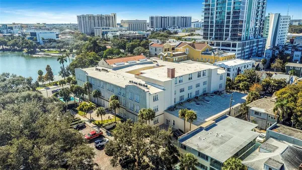 a aerial view of a house with a yard and a large pool