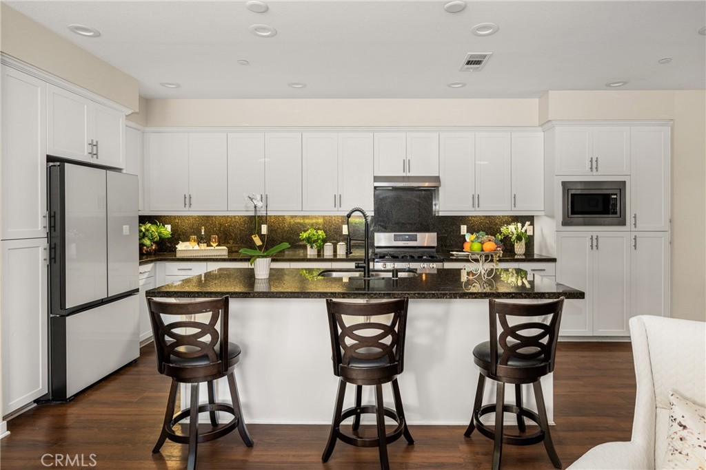 228 Borrego Irvine, CA 92618 - Photo 12 of 50 a kitchen with stainless steel appliances a stove a refrigerator and a dining table