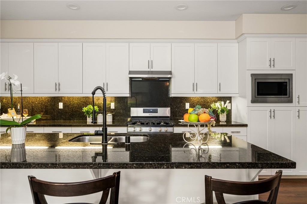 228 Borrego Irvine, CA 92618 - Photo 13 of 50 a kitchen with granite countertop a stove a sink and a granite counter tops