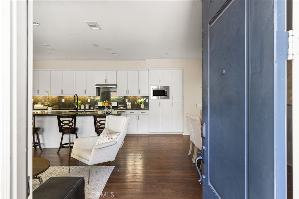 228 Borrego Irvine, CA 92618 - Photo 2 of 50 a living room with stainless steel appliances kitchen island granite countertop a refrigerator a stove a sink and white cabinets with wooden floor